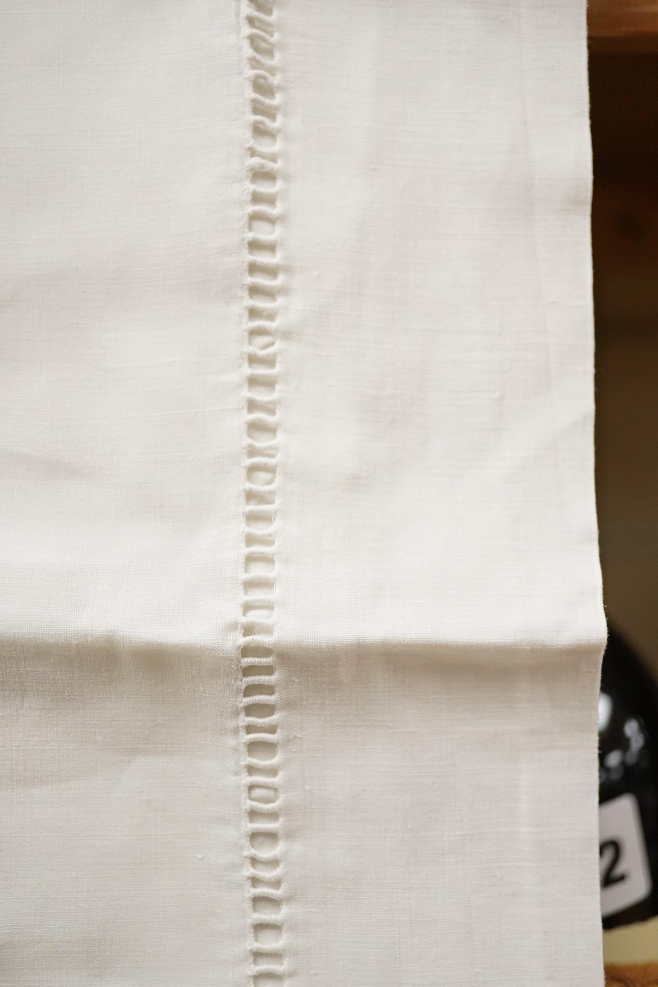 Two matching linen hand monogrammed sheets, one 216cm x 330cms, the other 212cm x 340 cms, together with three later monogrammed linen pillow cases and three embroidered cotton pillowcases.